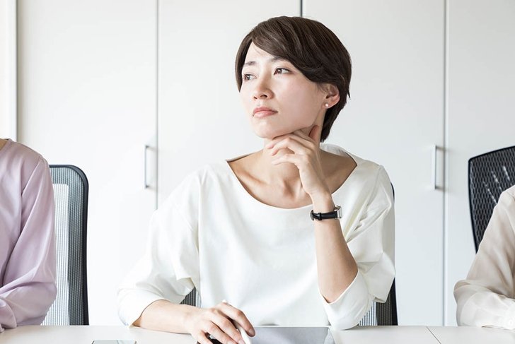 Thinking young woman in the office.