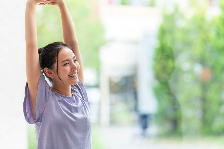 Young asian woman doing stretch. Health care. Body care.